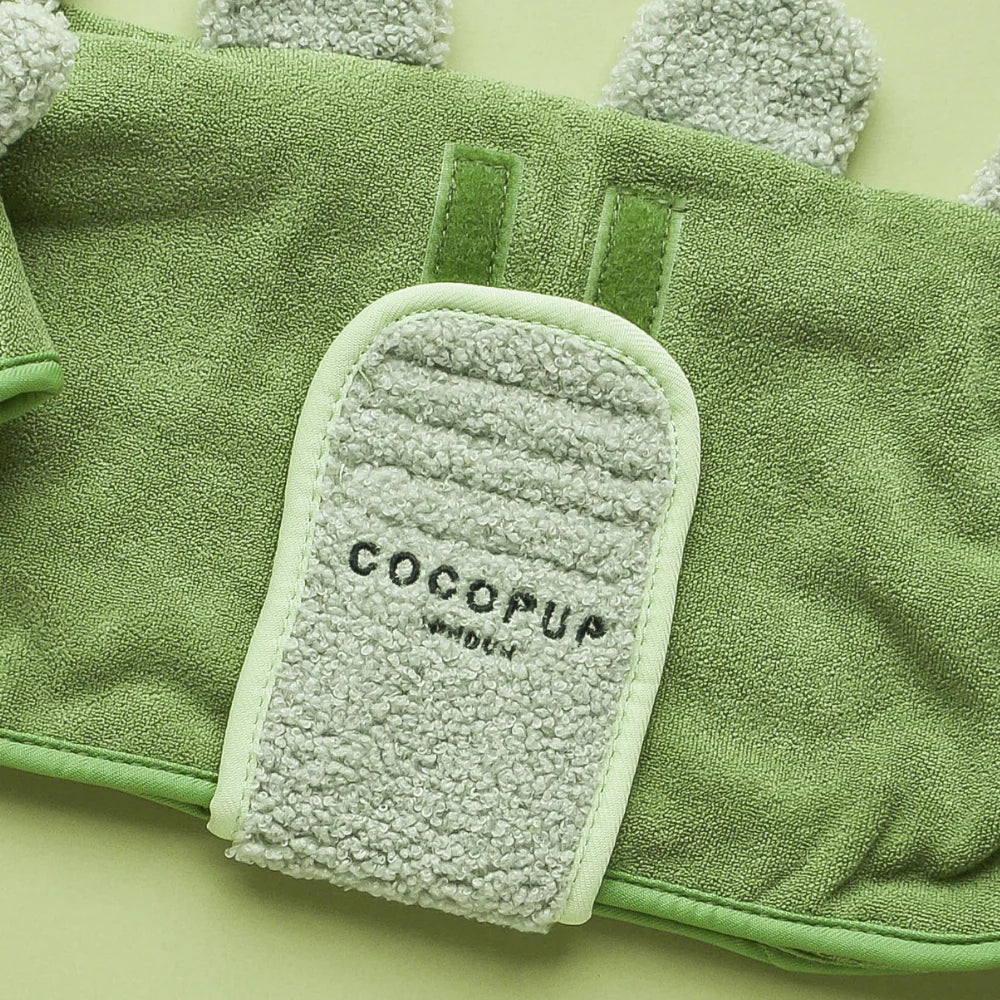 Green dog robe with 'Cocopup London' branding on a green background