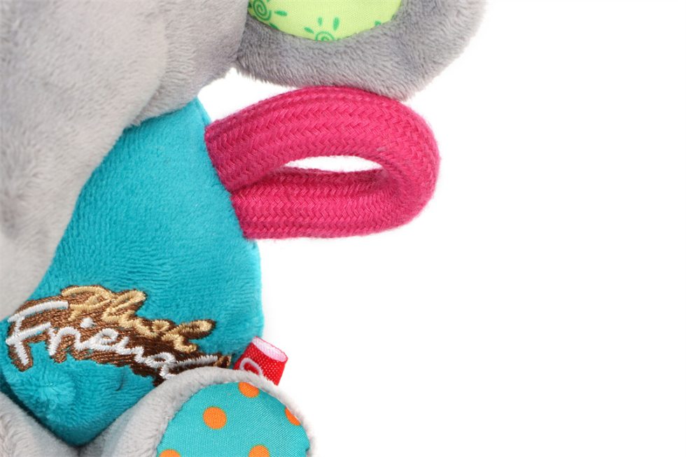 Close-up of a plush dog toy with colourful elements and 'Plush Friends' branding on a white background