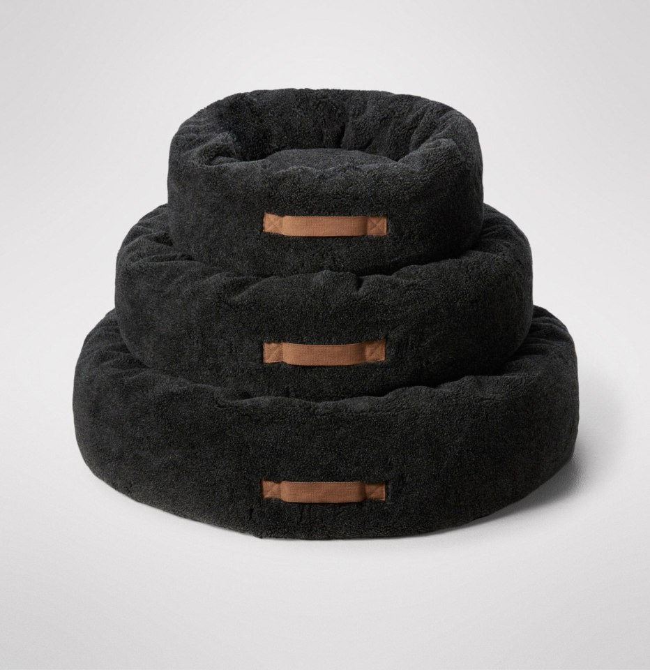 Three MiniJumbuk Sleep Calm Oasis Wool Dog Bed – Storm Grey in 3 different sizes, photographed on a clean light gray studio background.