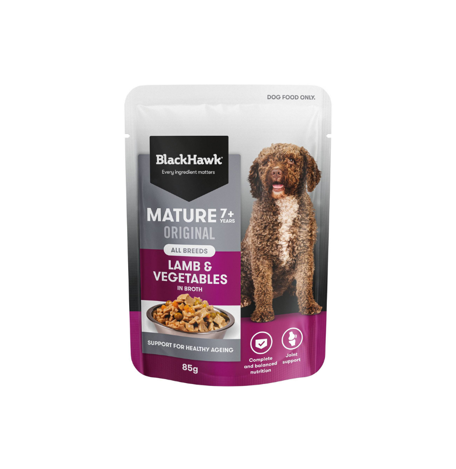 A 85g pouch of BlackHawk Mature 7+ Original Lamb & Vegetables dog wet food, featuring a brown curly-haired dog on the packaging against a plain white background.