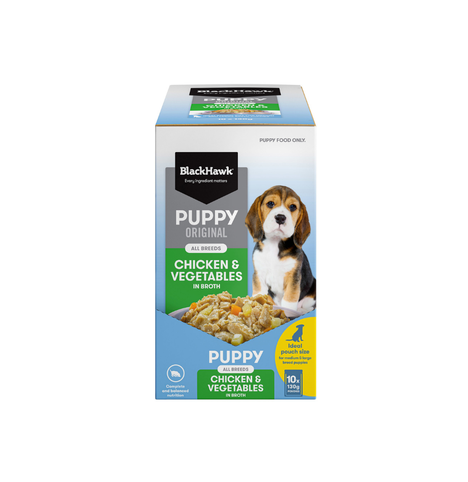 A box of BlackHawk Puppy Original Chicken & Vegetables wet dog food, featuring a picture of a beagle on the front, set against a plain white background.