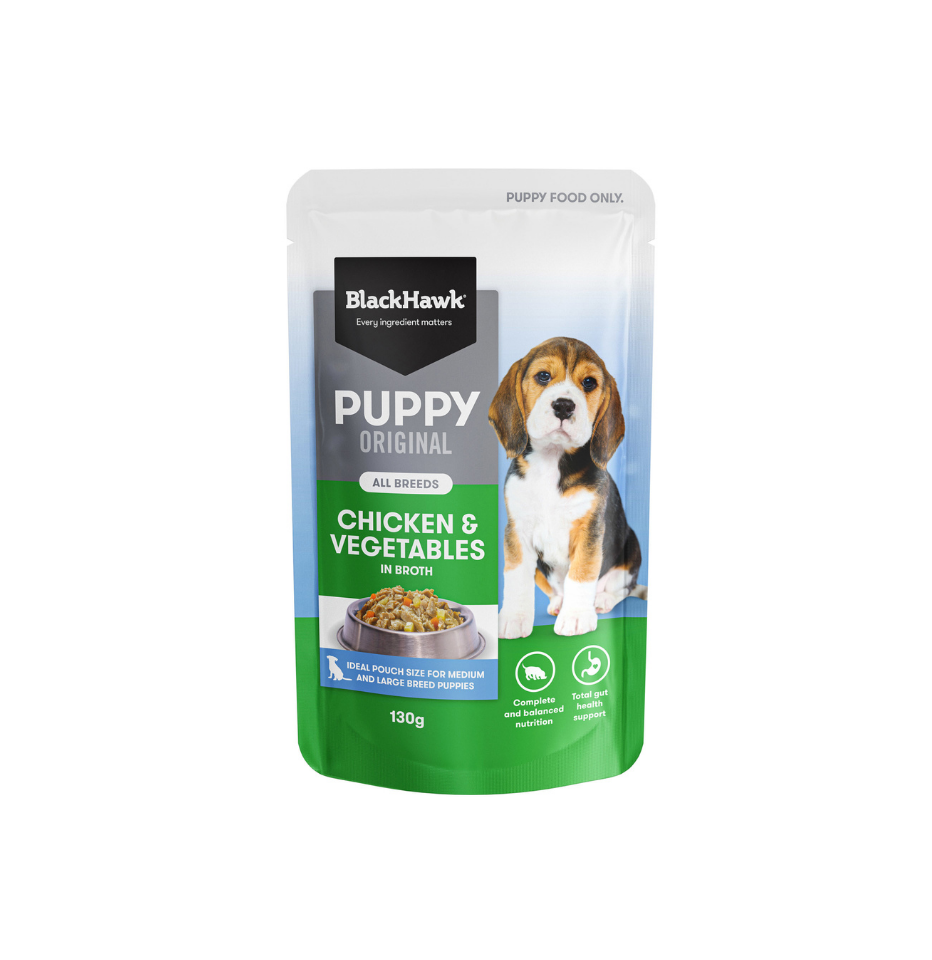 A 130g pouch of BlackHawk Puppy Original chicken and vegetables in broth dog wet food, featuring a black, white, and green label with a beagle puppy illustration.