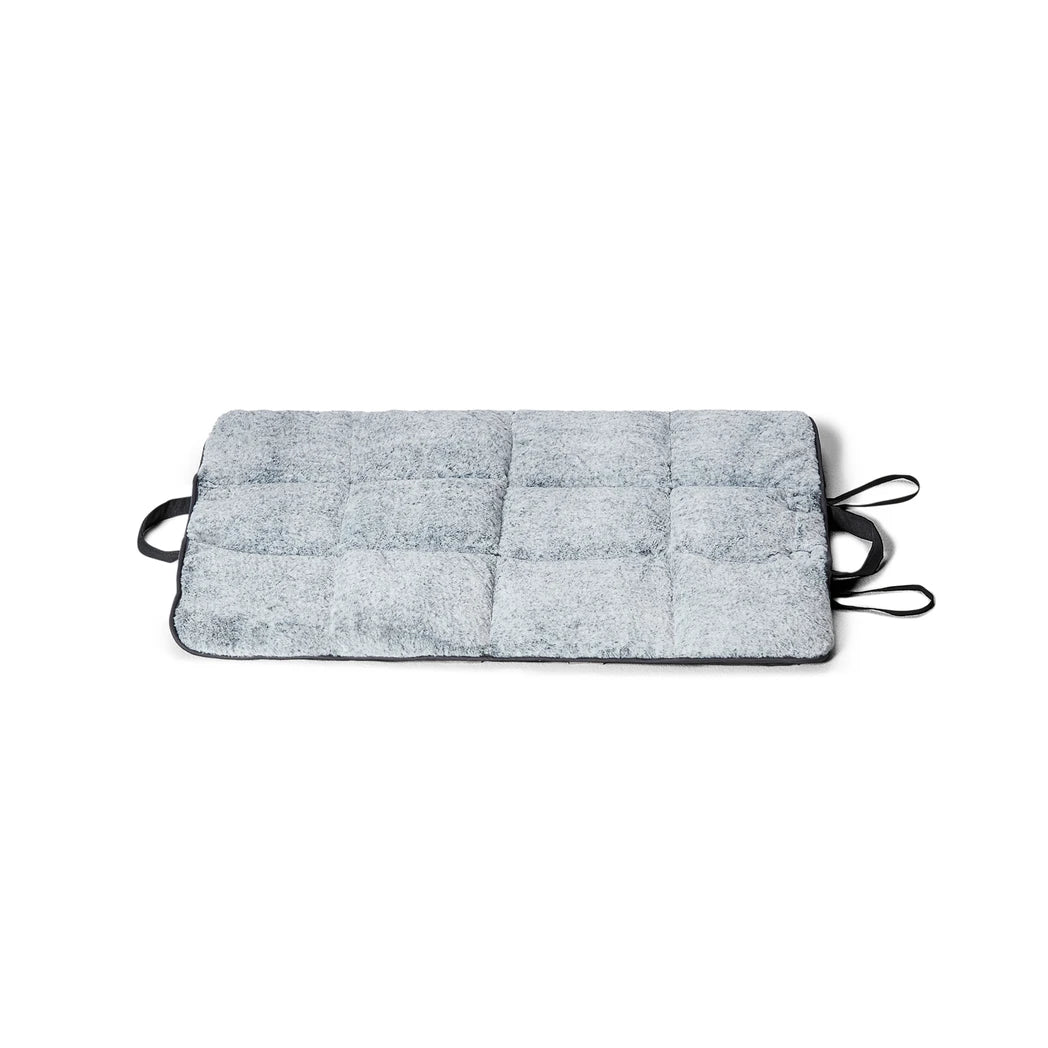 Snooza Cloud Comfort Washable Faux Fur Dog Travel Mat with handles on a white background