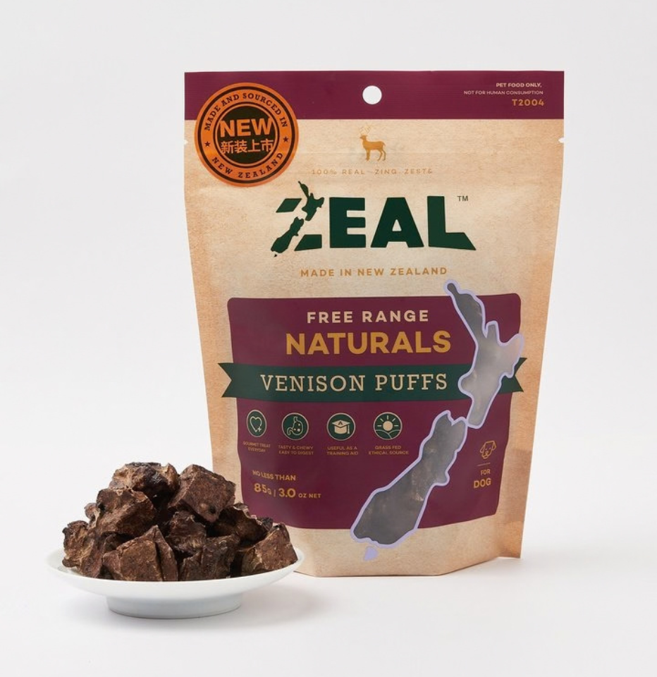 Zeal Free Range Naturals Venison Puffs dog treats, shown next to a small white dish filled with the puff treats on a light gray background.