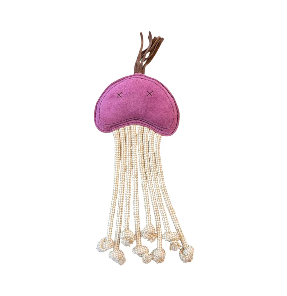 A jellyfish-shaped buffalo suede dog toy in purple with cream dangling beaded tentacles and a brown hanging loop, shown on a plain white background.