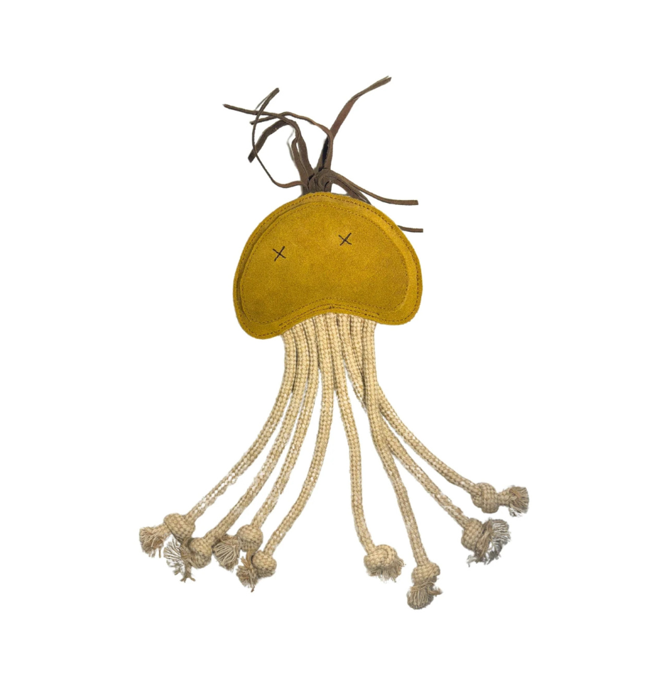 A handmade jellyfish-shaped dog buffalo suede toy in a wheat colour fabric head, dark brown twine tentacles, and cream-colored braided rope tentacles, shown against a plain white background.
