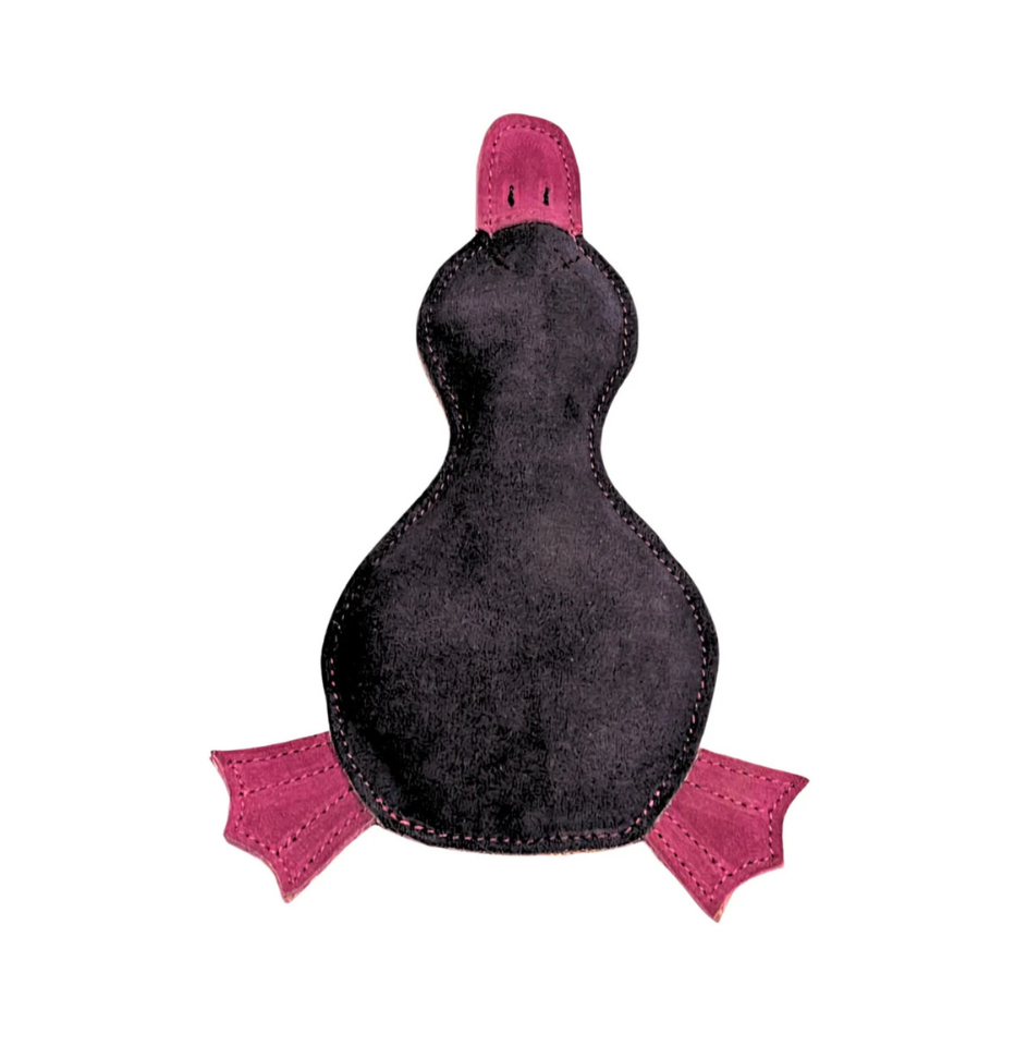 A platypus-shaped buffalo suede dog toy in navy and pink in a white background