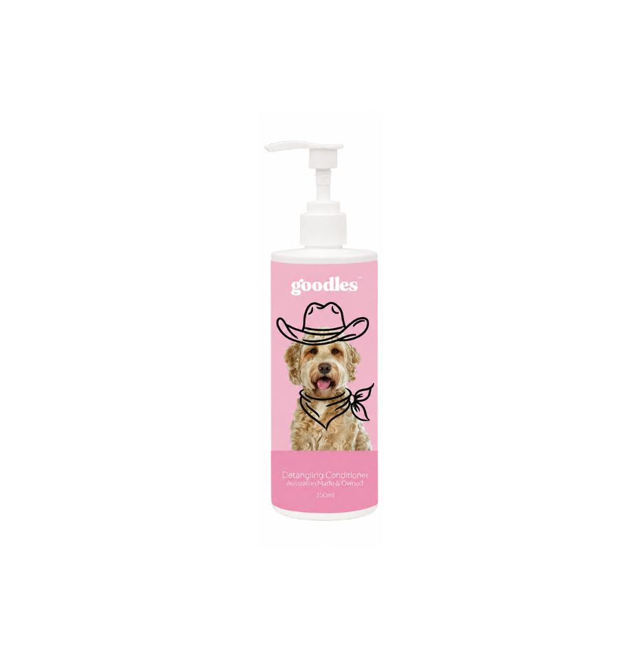 A bottle of Goodies Dog Washing & Conditioning Shampoo with a pink label featuring a cartoon dog wearing a cowboy hat, on a white background.