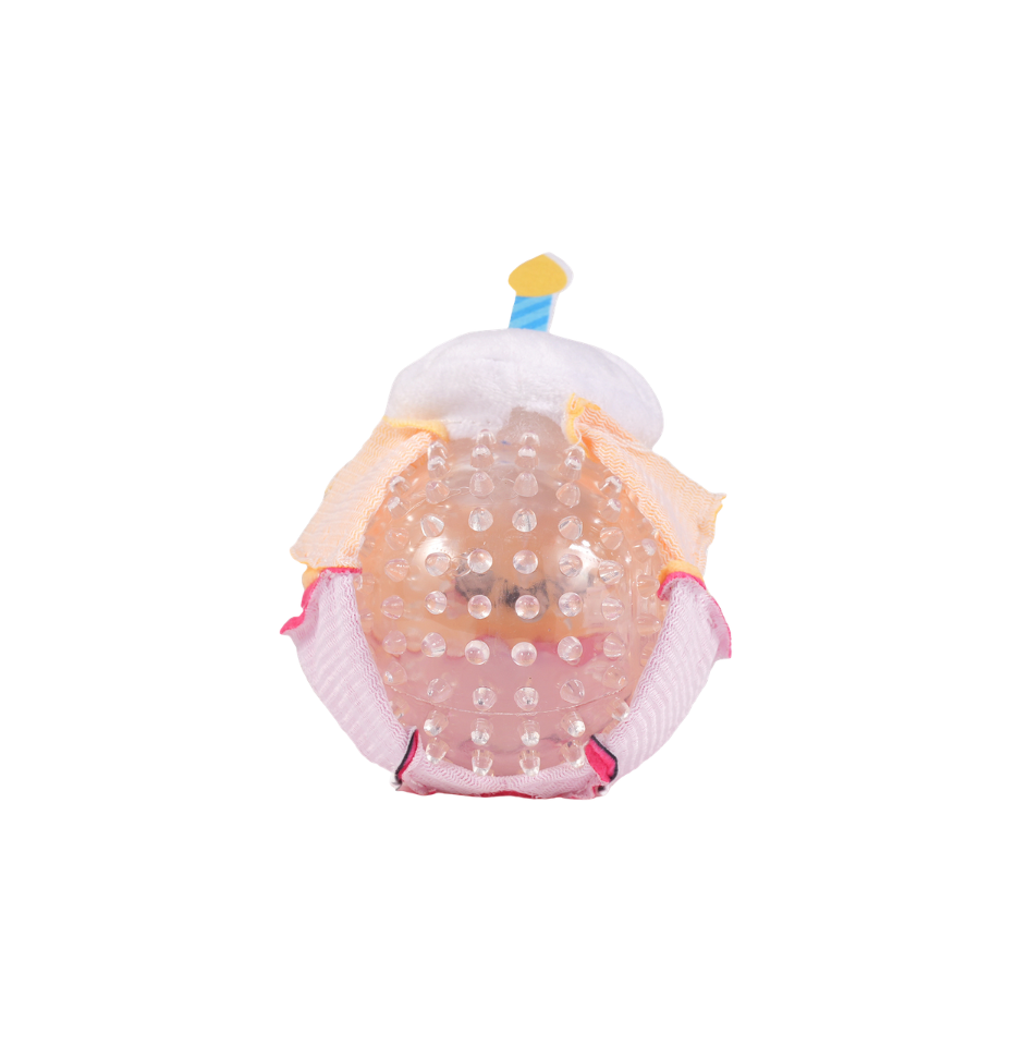 Hugsmart Yappy Birthday Super Ball Cupcake dog toy showing the internal textured squeaker ball, with pink and peach plush fabric panels, white fluffy top and candle detail