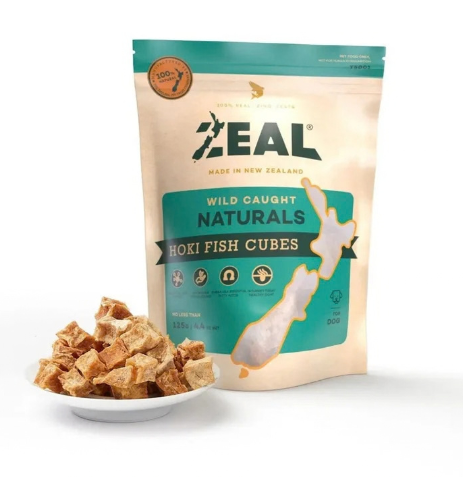 Package of Zeal Free Range Naturals Hoki Fish Cubes for dogs, 125g, with a small plate displaying the hoki fish cubes