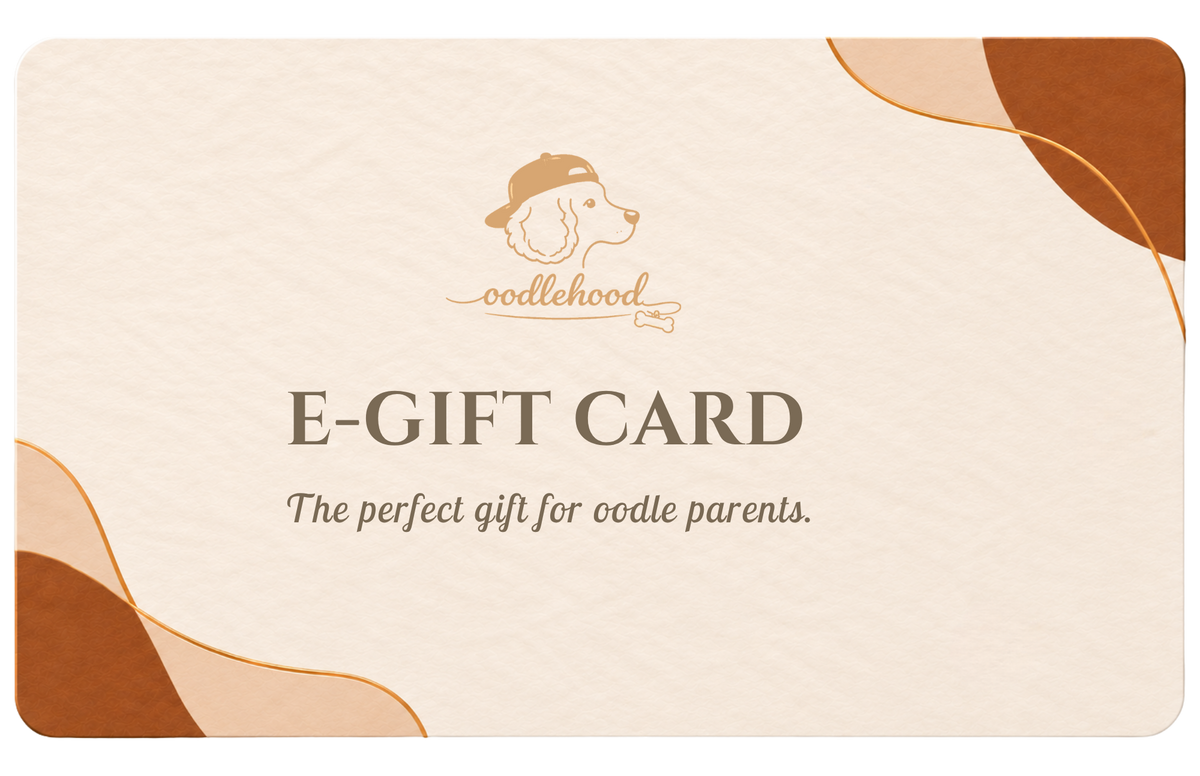oodlehood e-gift card, featuring a cream-colored textured background with abstract brown and gold shapes in the corners. The center displays the oodlehood logo (a dog head wearing a cap) and the text 'E-GIFT CARD' and 'The perfect gift for oodle parents.