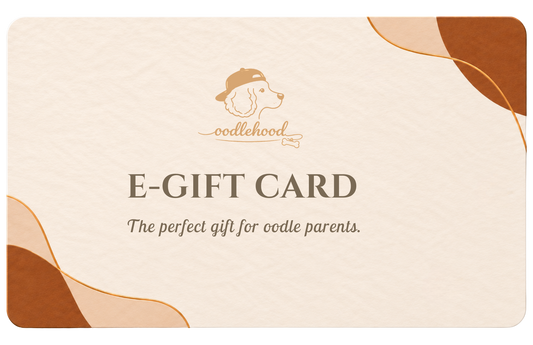 oodlehood e-gift card, featuring a cream-colored textured background with abstract brown and gold shapes in the corners. The center displays the oodlehood logo (a dog head wearing a cap) and the text 'E-GIFT CARD' and 'The perfect gift for oodle parents.